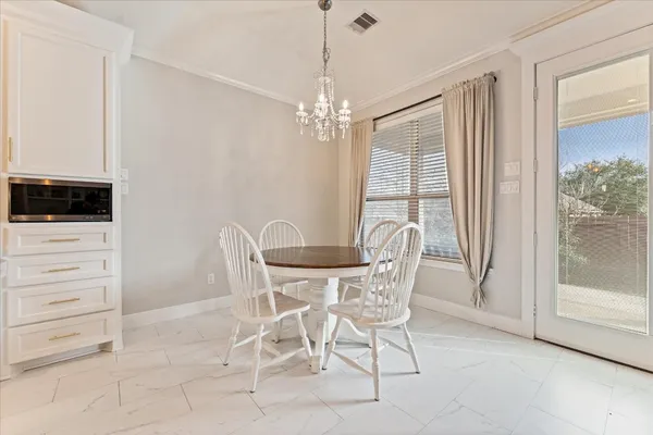 a view of a dining room with furniture and window