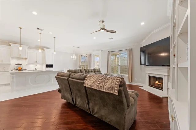 a living room with furniture fireplace and flat screen tv