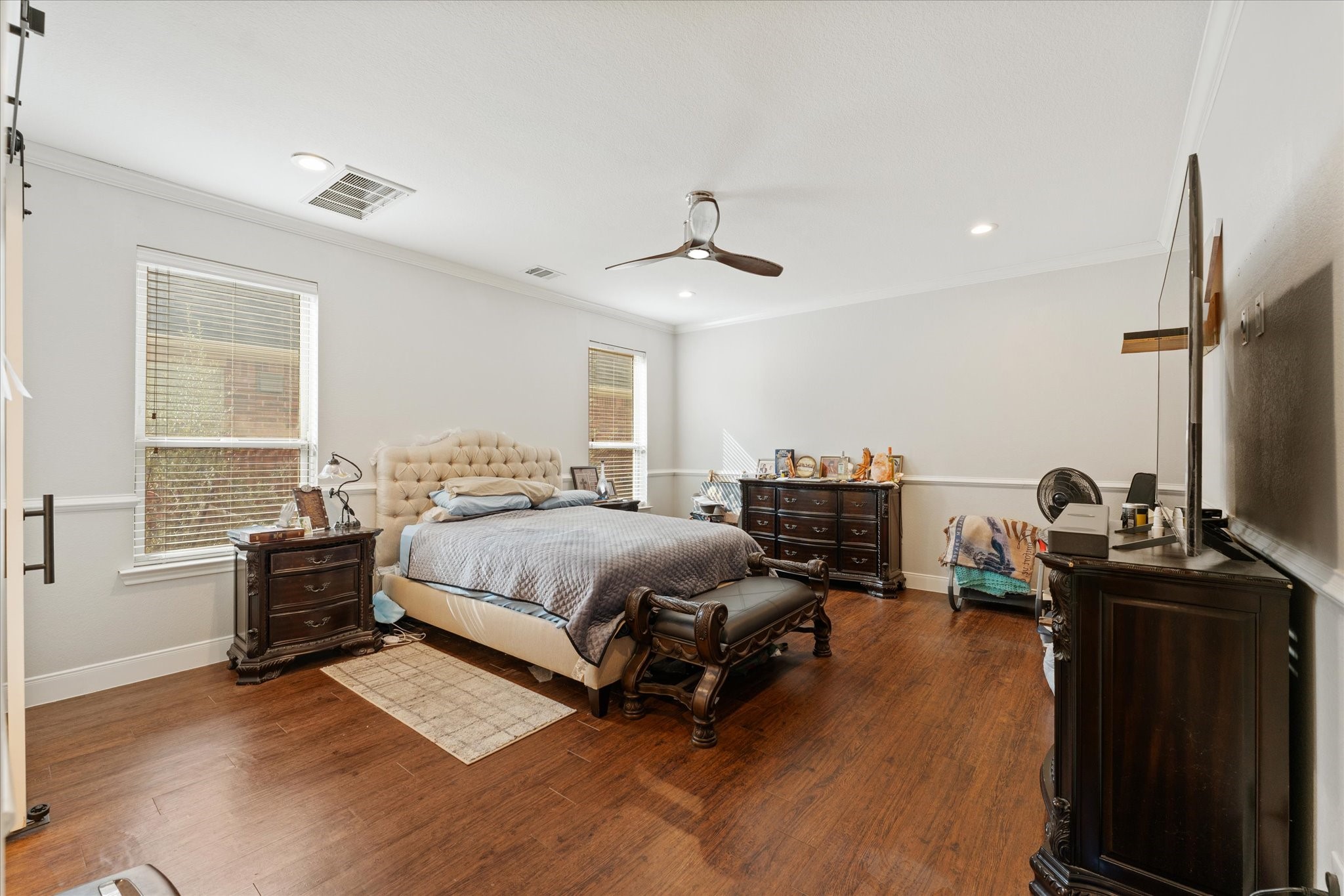 1706 Elmside Court Conroe, TX 77301 - Photo 21 of 36 a spacious bedroom with a bed and a desk