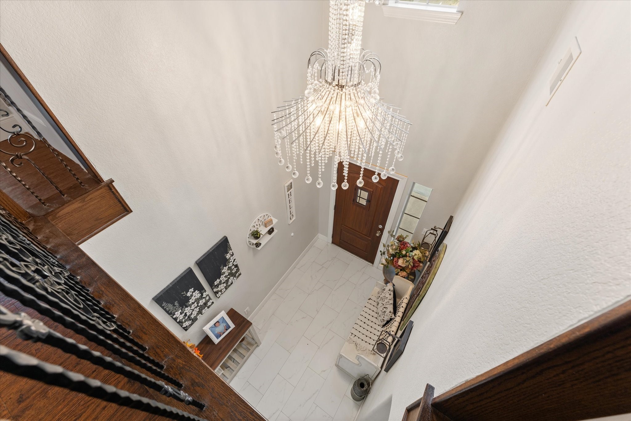 1706 Elmside Court Conroe, TX 77301 - Photo 26 of 37 Speakeasy front door compliments the wrought iron balusters following the stairway.
