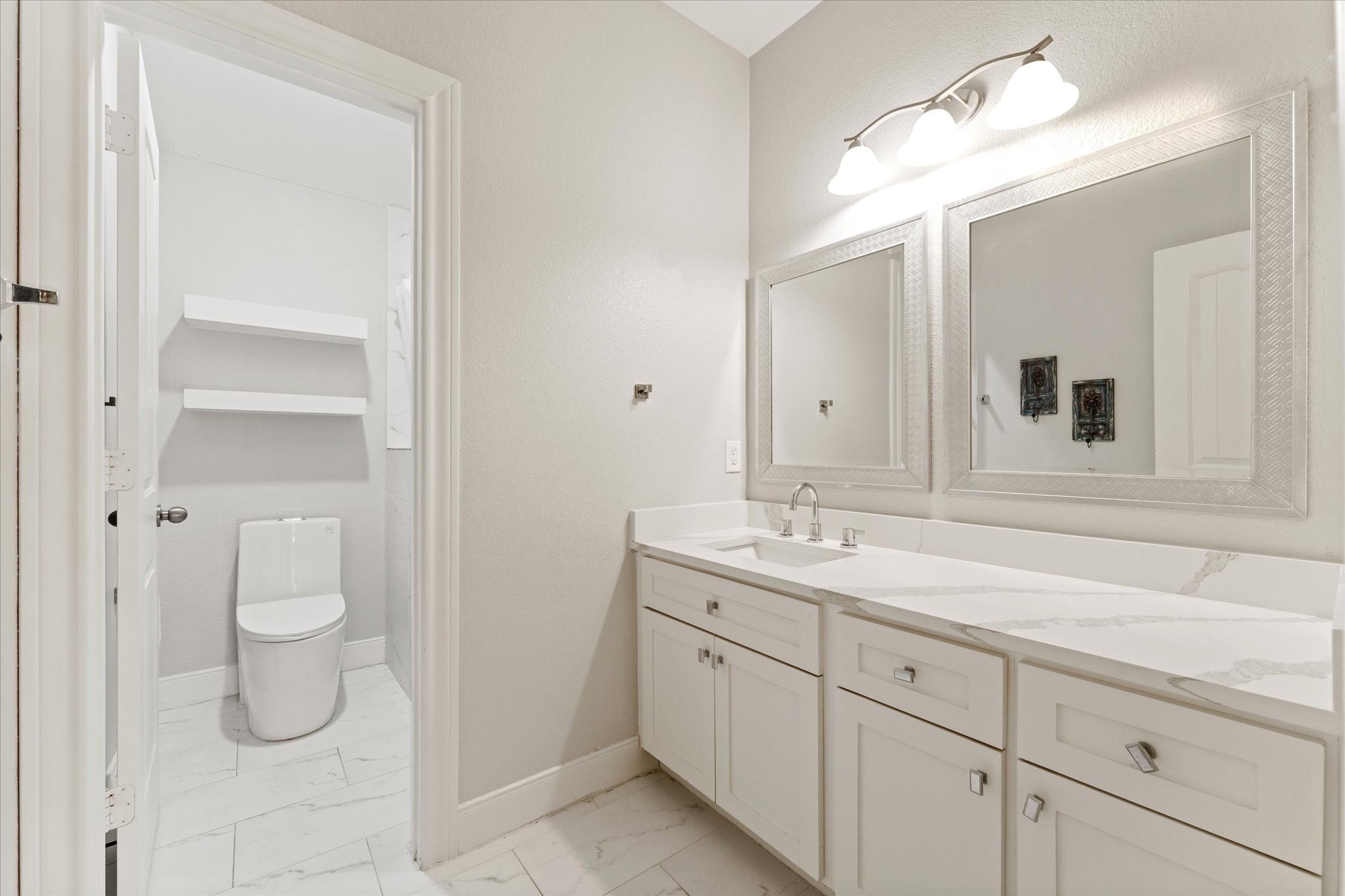 1706 Elmside Court Conroe, TX 77301 - Photo 27 of 36 a bathroom with a sink and a mirror