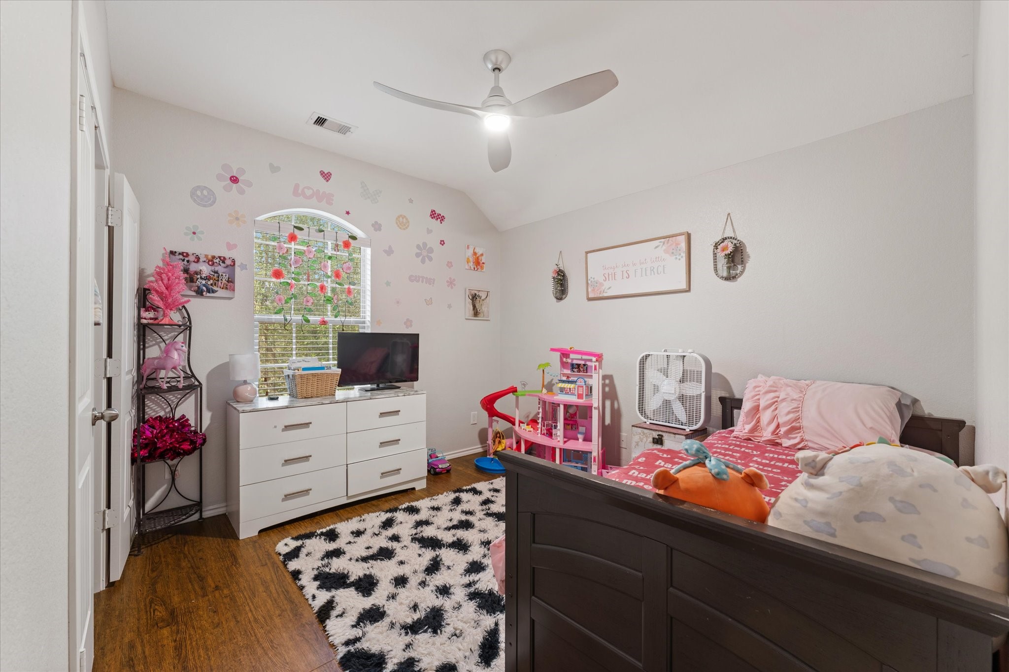 1706 Elmside Court Conroe, TX 77301 - Photo 29 of 36 a bedroom with a bed and a chandelier