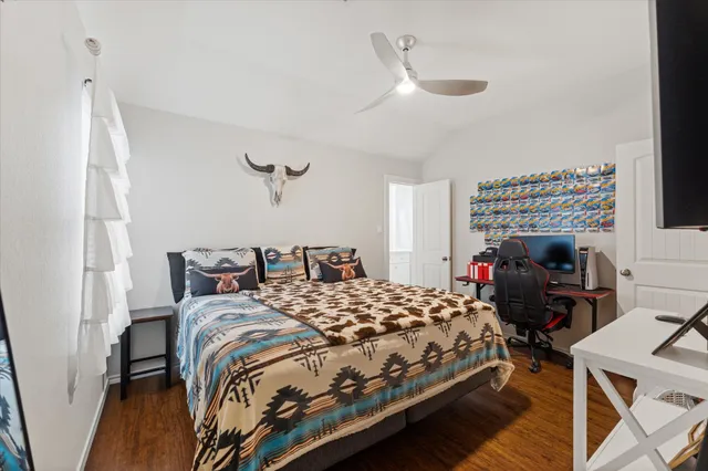 a bedroom with a bed and a desk