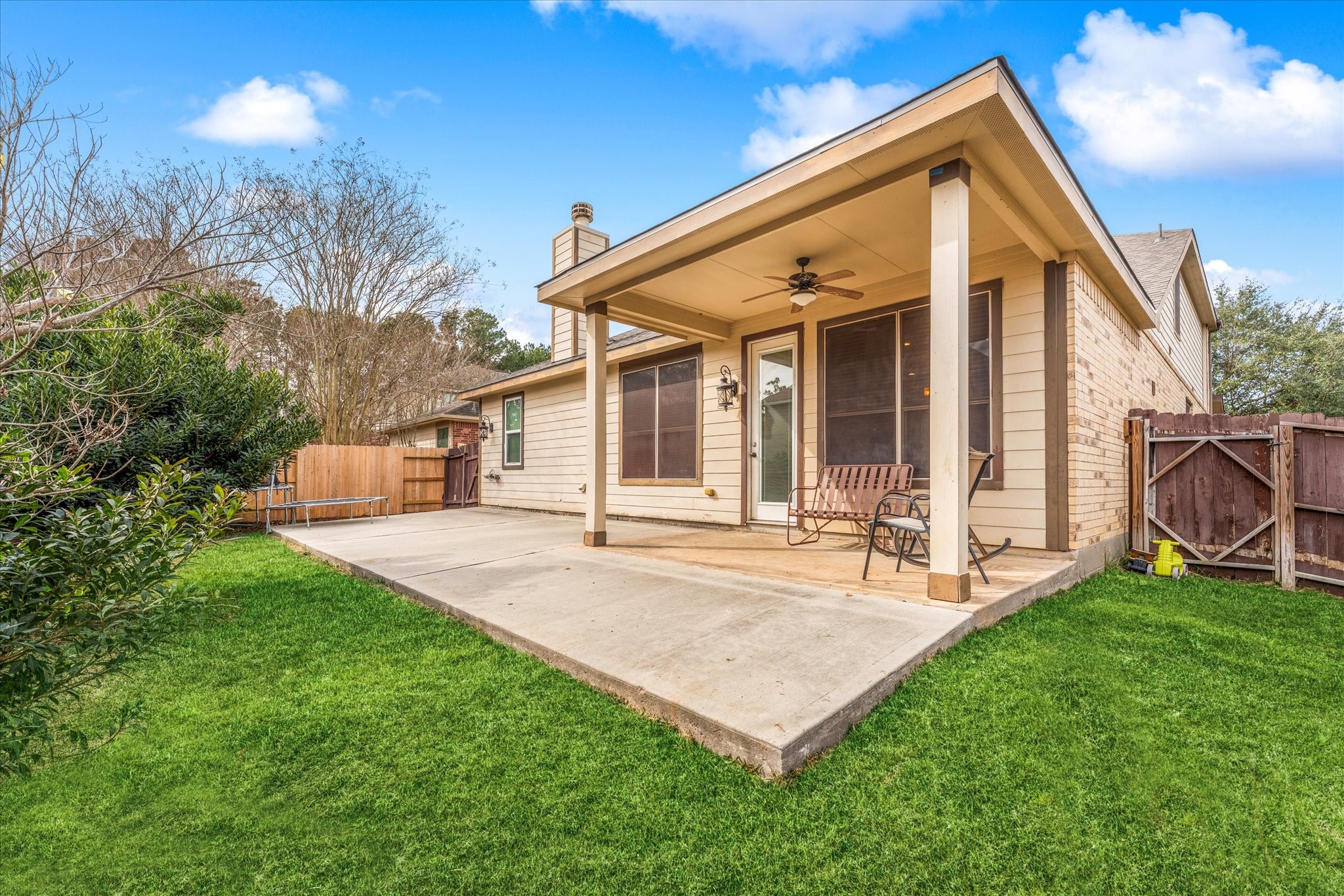 1706 Elmside Court Conroe, TX 77301 - Photo 34 of 36 a front view of a house with a yard and porch