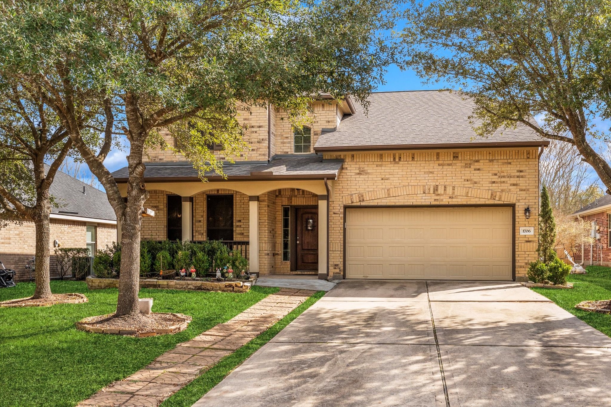1706 Elmside Court Conroe, TX 77301 - Photo 6 of 36 a front view of a house with a yard and potted plants