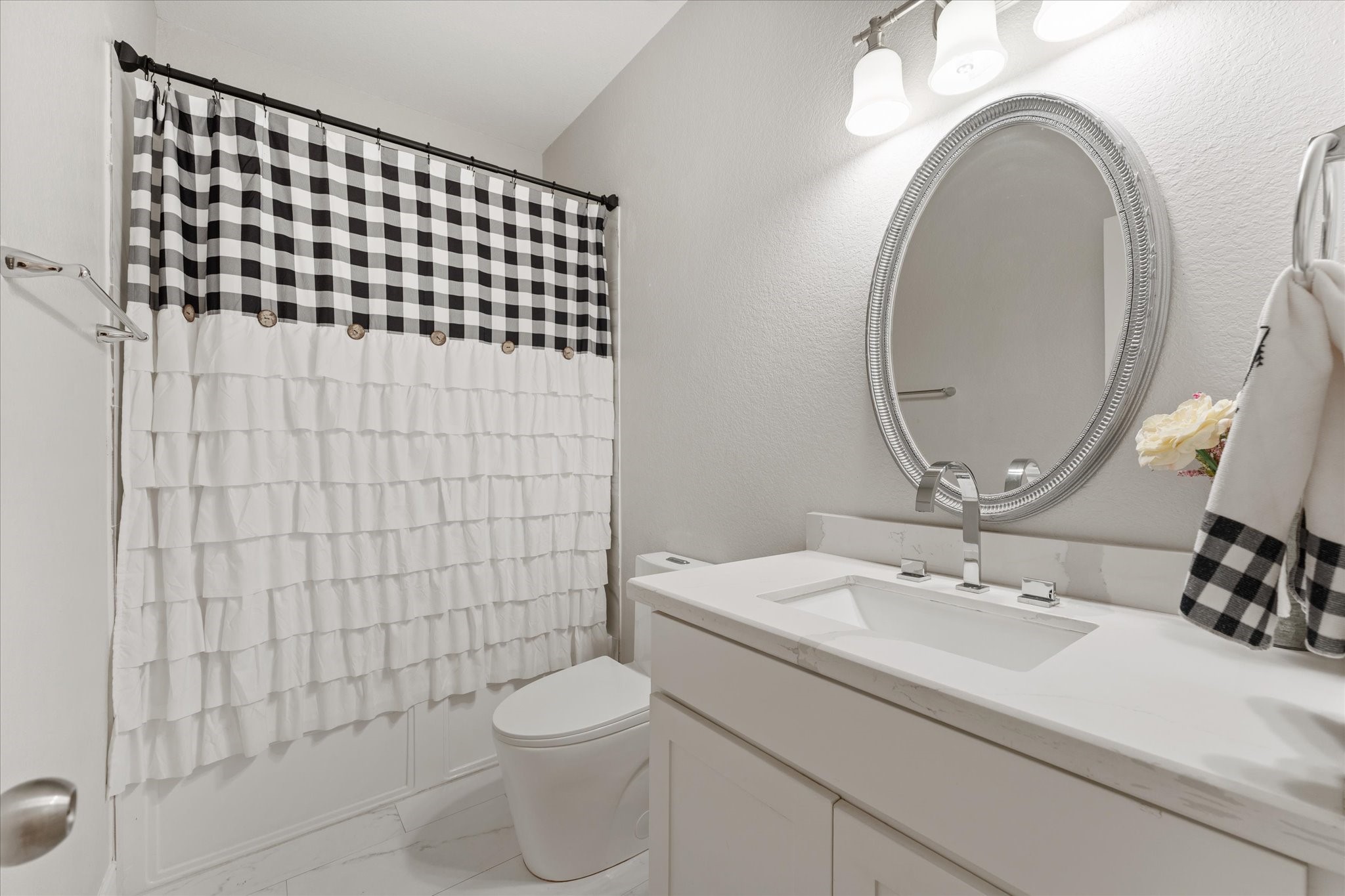 1706 Elmside Court Conroe, TX 77301 - Photo 9 of 36 a bathroom with a sink a toilet and a mirror