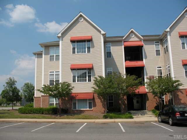 2511 Friedland Place, Unit 200 Raleigh, NC 27617 - Photo 1 of 12 a front view of a house with a yard and garage