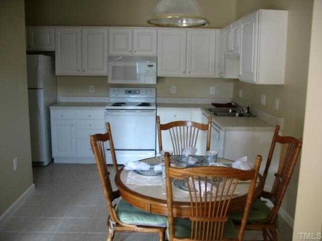 2511 Friedland Place, Unit 200 Raleigh, NC 27617 - Photo 3 of 12 a table and chairs in a kitchen