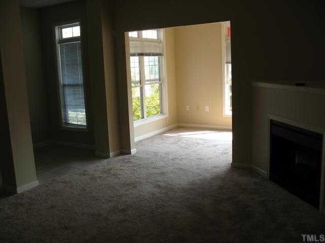 2511 Friedland Place, Unit 200 Raleigh, NC 27617 - Photo 4 of 12 an empty room with windows