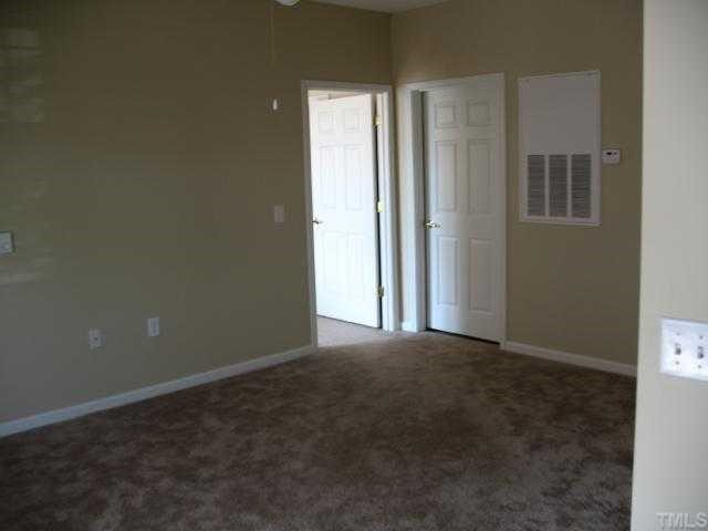 2511 Friedland Place, Unit 200 Raleigh, NC 27617 - Photo 5 of 12 a view of empty room with windows