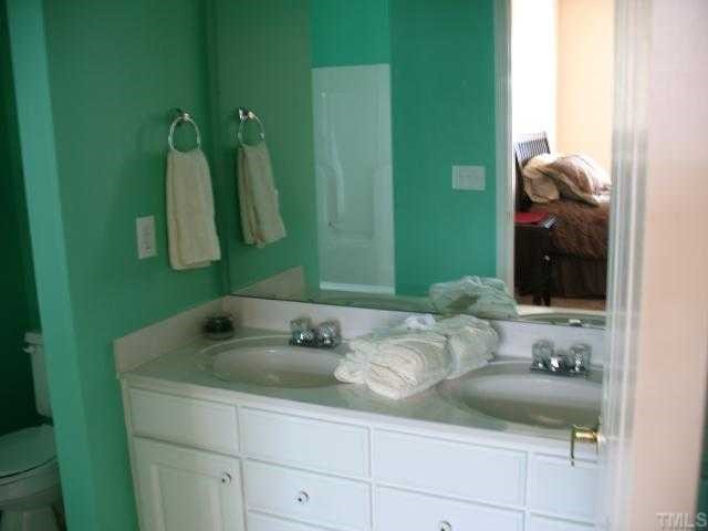2511 Friedland Place, Unit 200 Raleigh, NC 27617 - Photo 9 of 12 a bathroom with a sink and a mirror