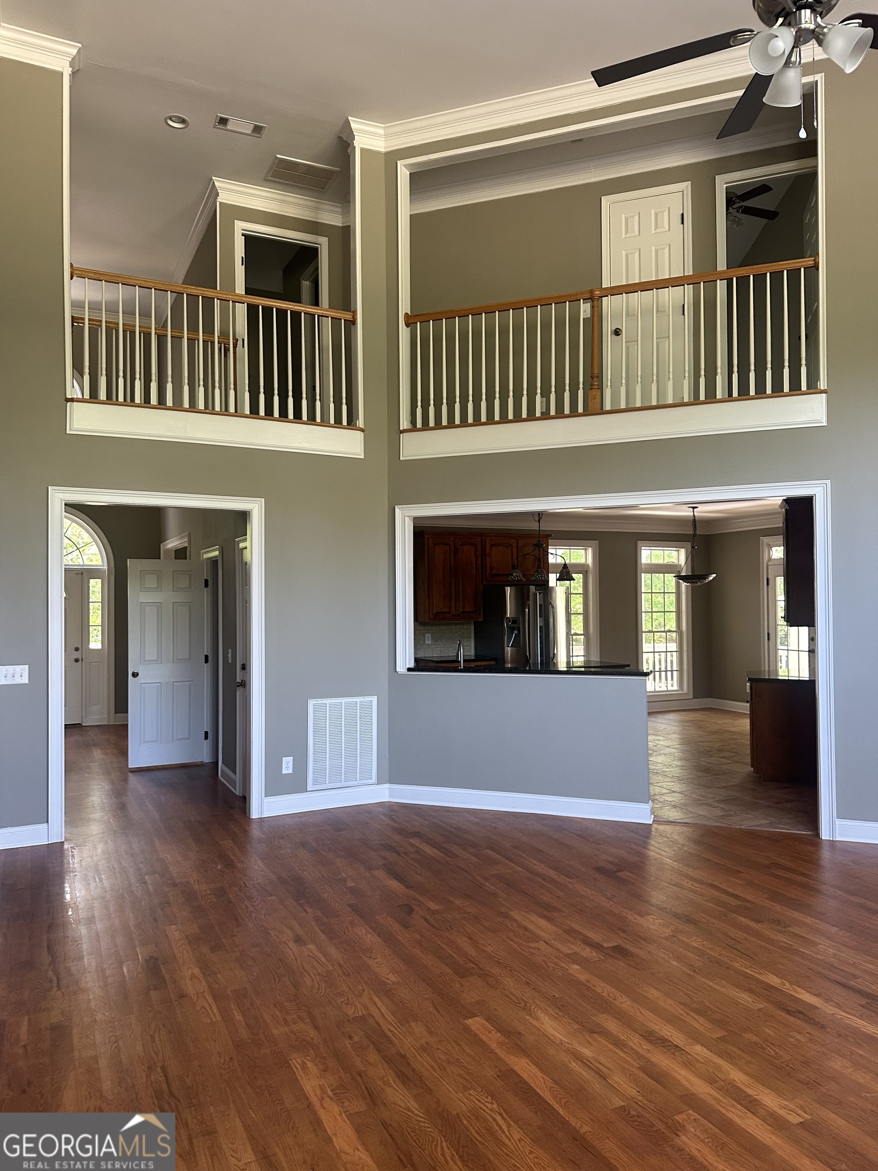 65 Spratlin Way Hull, GA 30646 - Photo 11 of 35 an empty room with wooden floor and windows