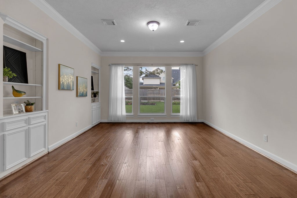 7306 Starflower Katy, TX 77494 - Photo 12 of 50 wooden floor in an empty room with a window