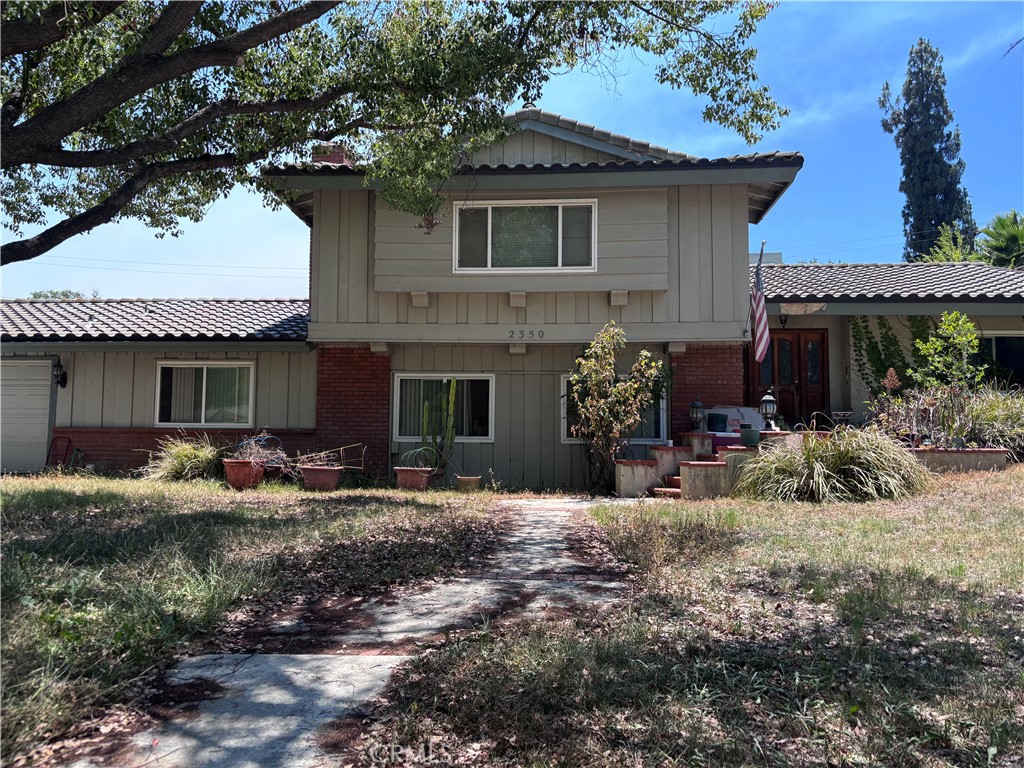 a front view of house with yard and seating space