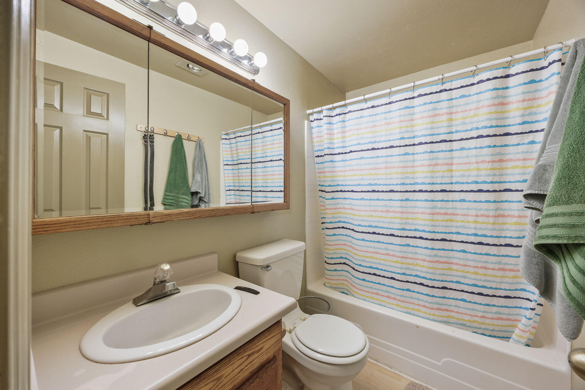 75 Wimer Street Ashland, OR 97520 - Photo 37 of 44 a bathroom with a sink a toilet and shower curtain