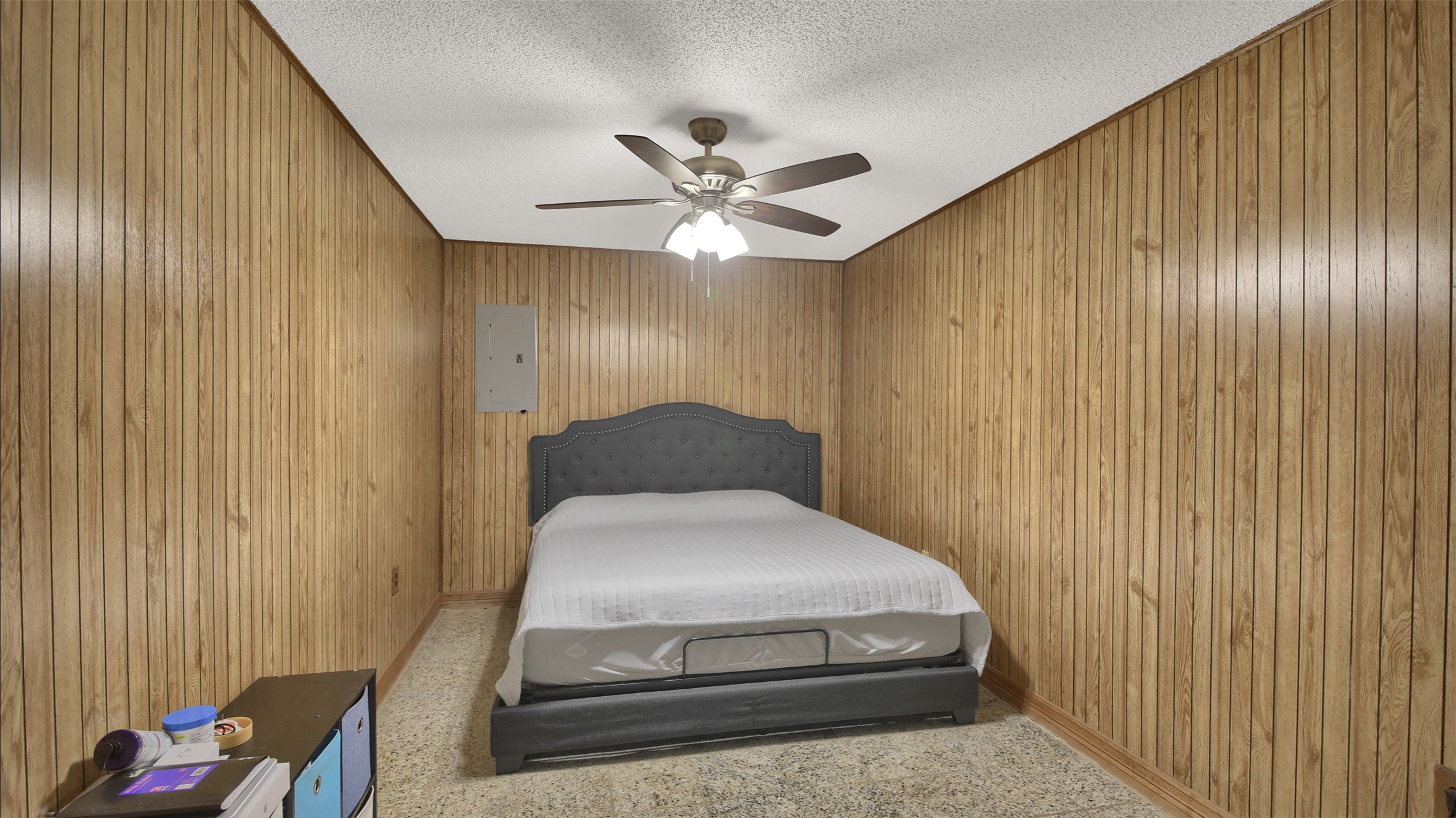 191 Jordan Lane Elgin, TX 78621 - Photo 12 of 29 Classic wood paneling lines the walls of this cozy bedroom with carpet flooring.