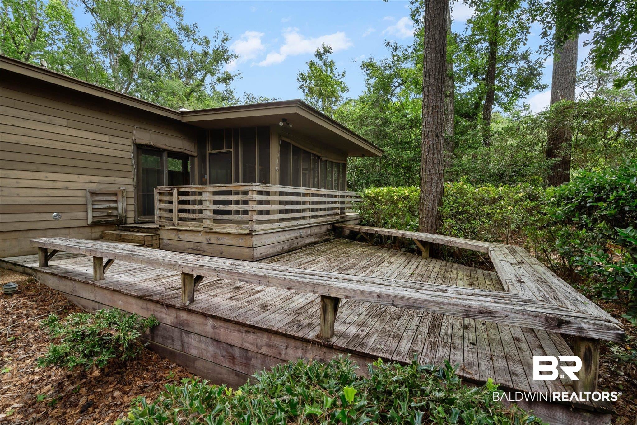 3500 Venetia Road Mobile, AL 36605 - Photo 16 of 56 Multi-level wood deck featuring built-in benches and a screened porch
