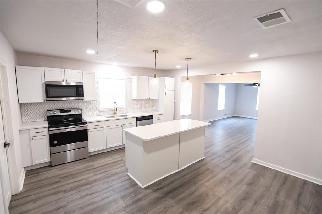 820 Allen Street Denton, TX 76205 - Photo 1 of 1 a kitchen with a sink cabinets and wooden floor