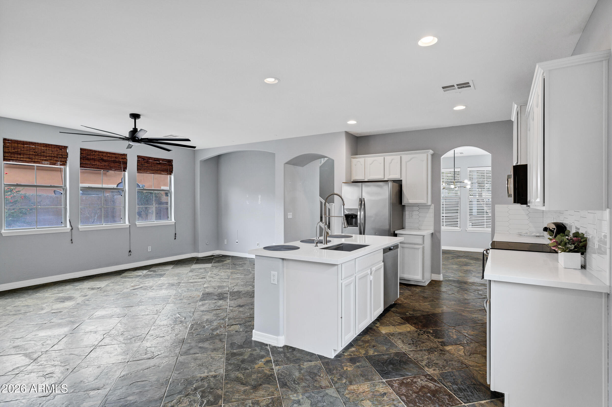 20982 West Edith Way Buckeye, AZ 85396 - Photo 12 of 57 a kitchen with stainless steel appliances granite countertop a stove a sink and a refrigerator