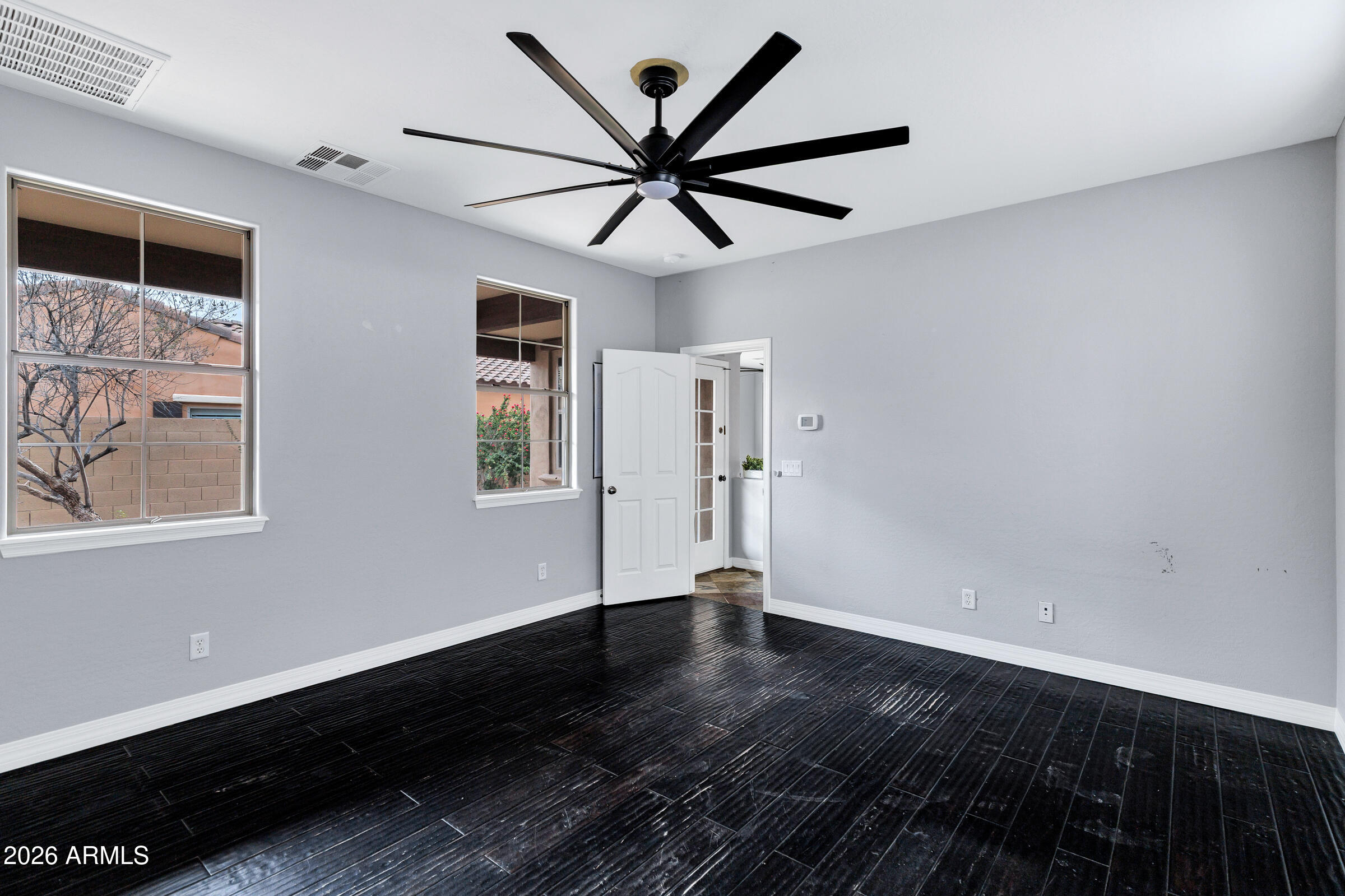 20982 West Edith Way Buckeye, AZ 85396 - Photo 22 of 57 a view of a livingroom with wooden floor and a ceiling fan