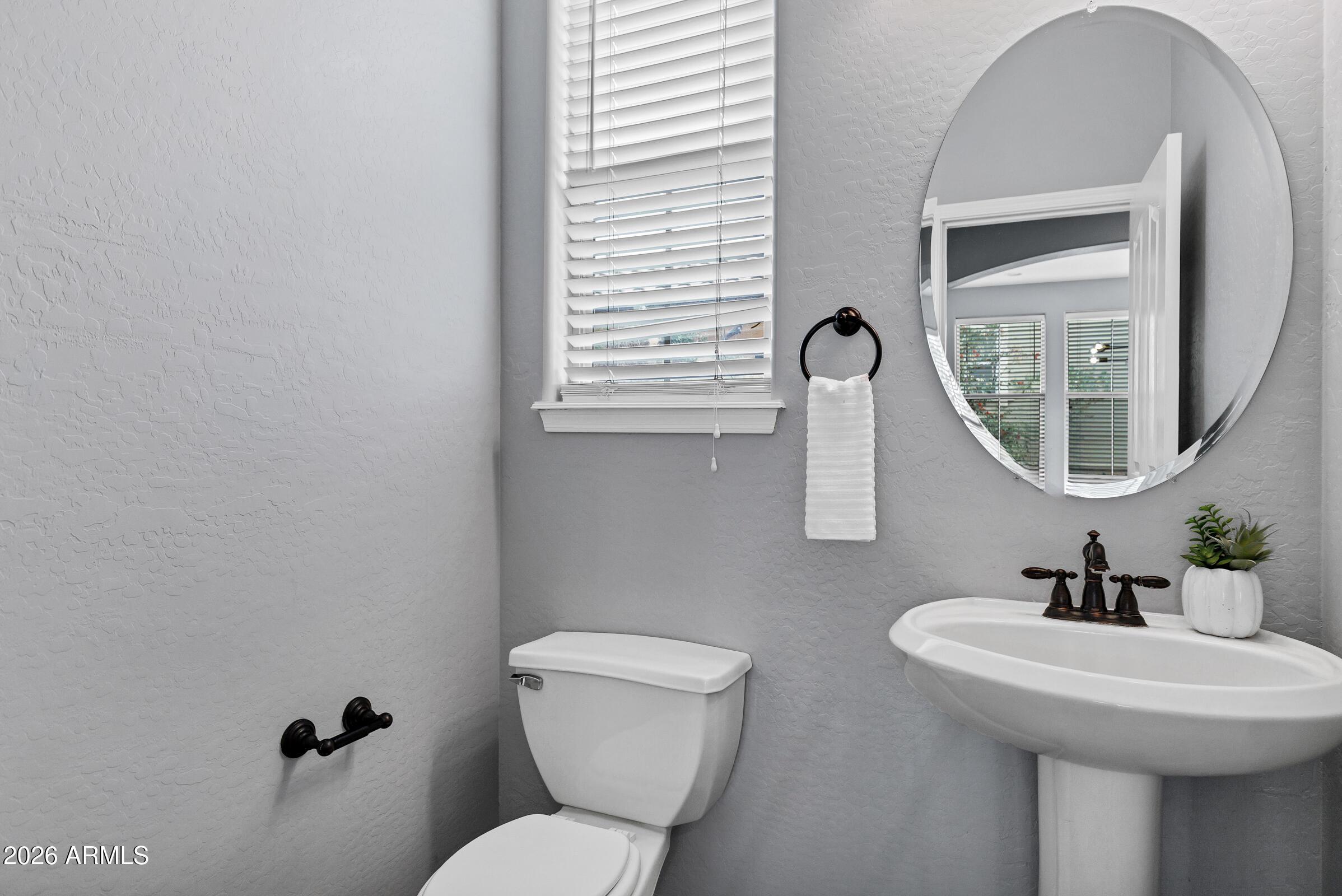 20982 West Edith Way Buckeye, AZ 85396 - Photo 25 of 57 a bathroom with a toilet sink and mirror