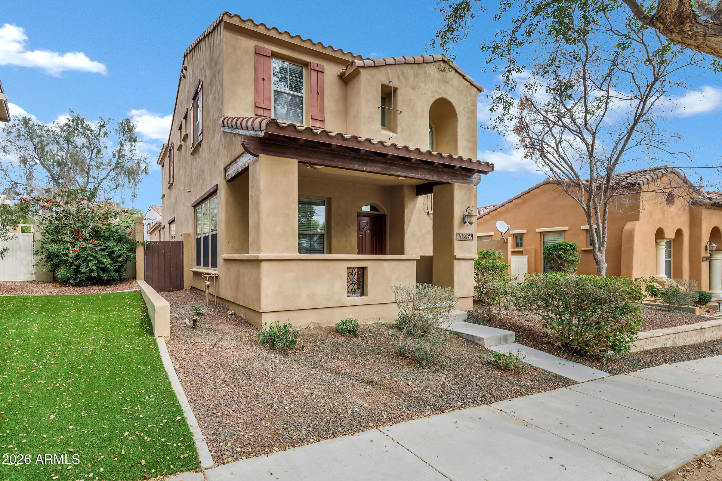 20982 West Edith Way Buckeye, AZ 85396 - Photo 3 of 57 a front view of a house with garden