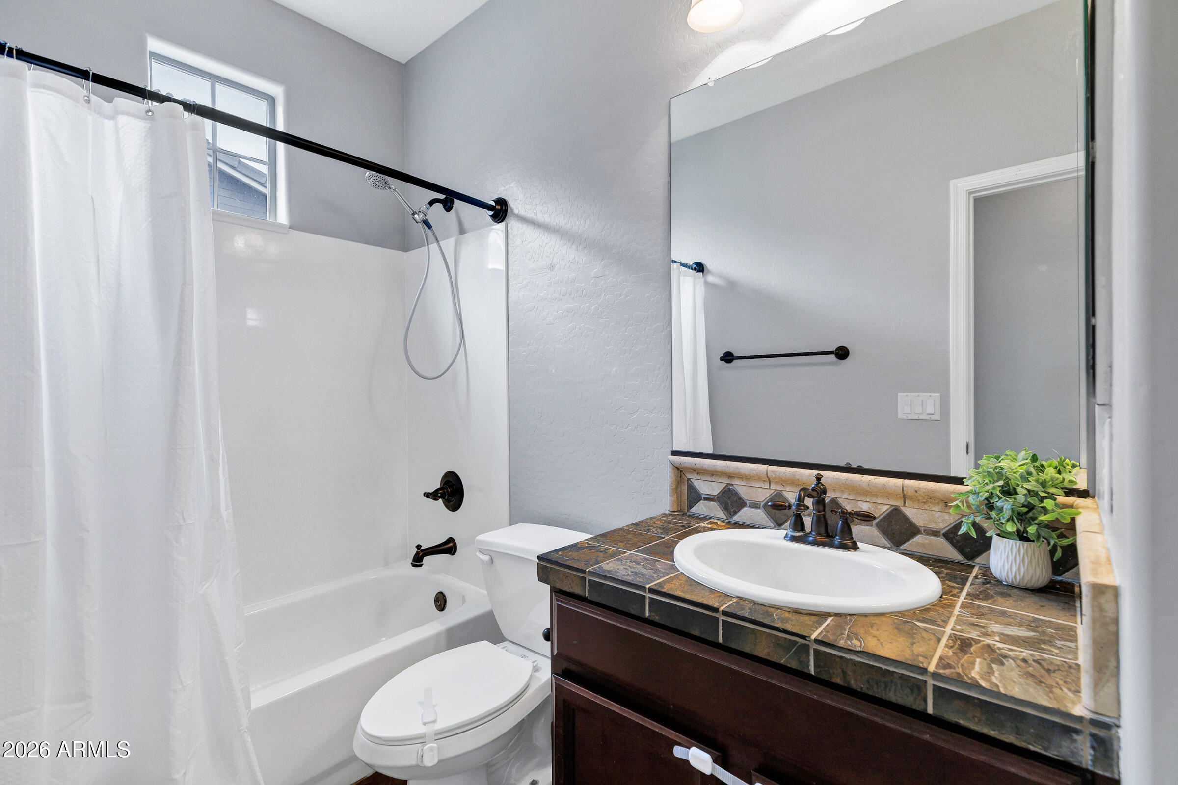 20982 West Edith Way Buckeye, AZ 85396 - Photo 31 of 57 a bathroom with a granite countertop sink toilet a mirror and shower