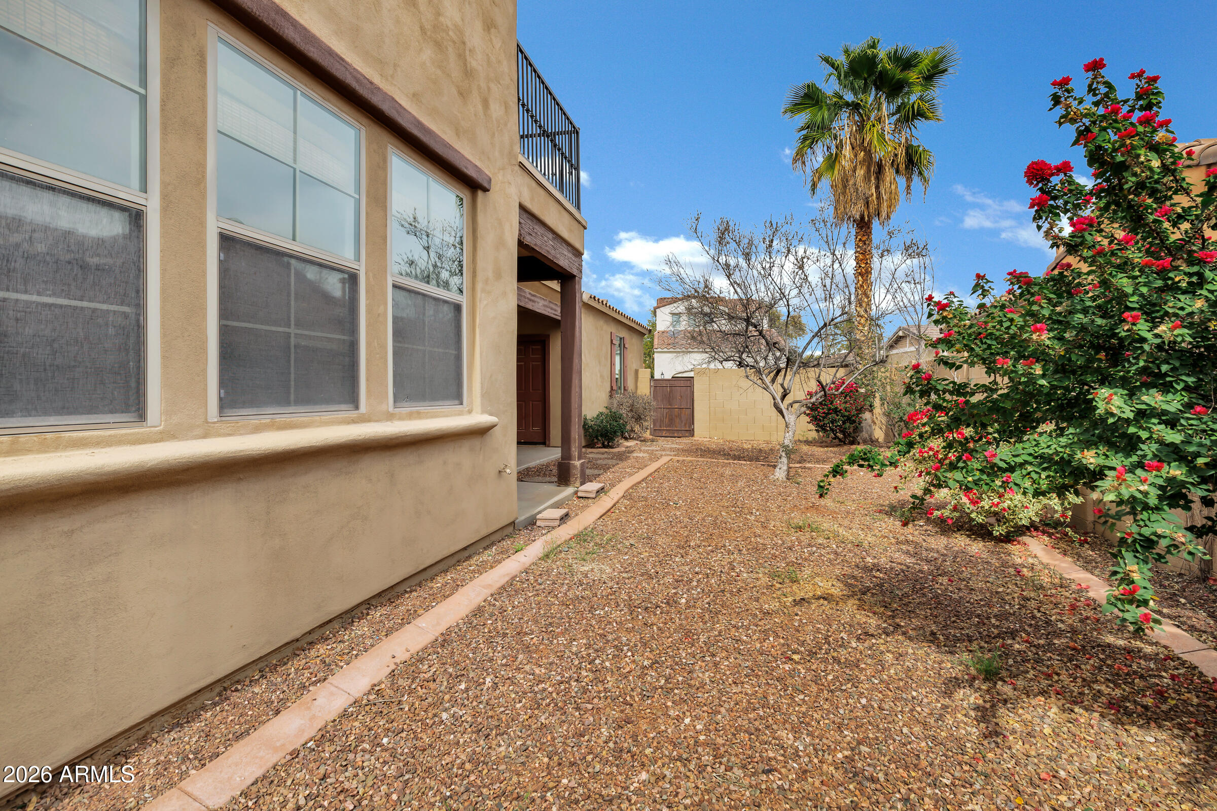 20982 West Edith Way Buckeye, AZ 85396 - Photo 44 of 57 a view of a house with a flower garden