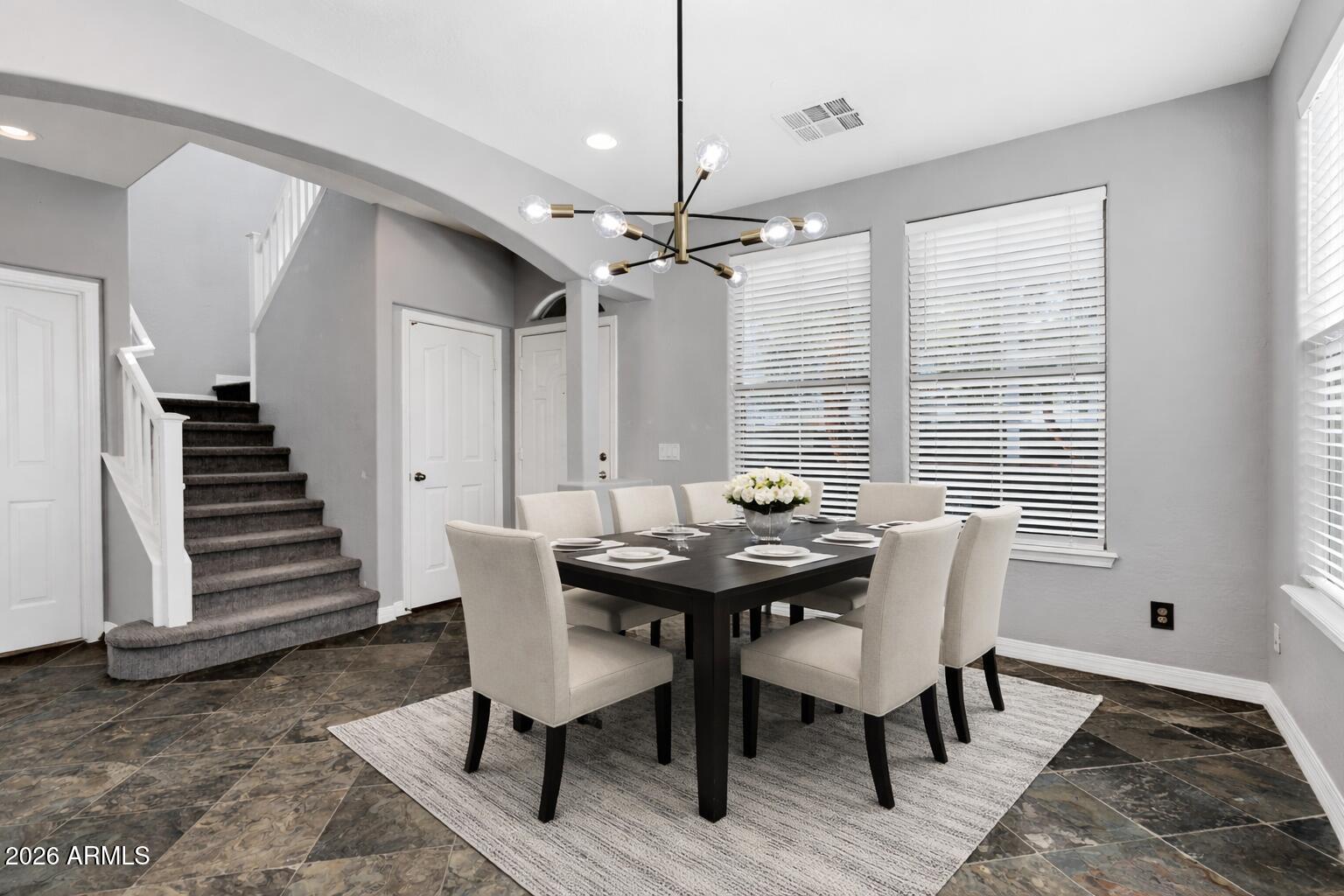20982 West Edith Way Buckeye, AZ 85396 - Photo 9 of 57 a view of a dining room with furniture window and wooden floor