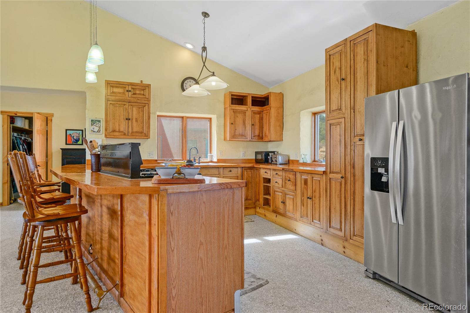 13045 Picketwire Road Boncarbo, CO 81024 - Photo 5 of 40 a view of kitchen with stainless steel appliances kitchen island granite countertop a refrigerator a stove and a dining table with wooden floor