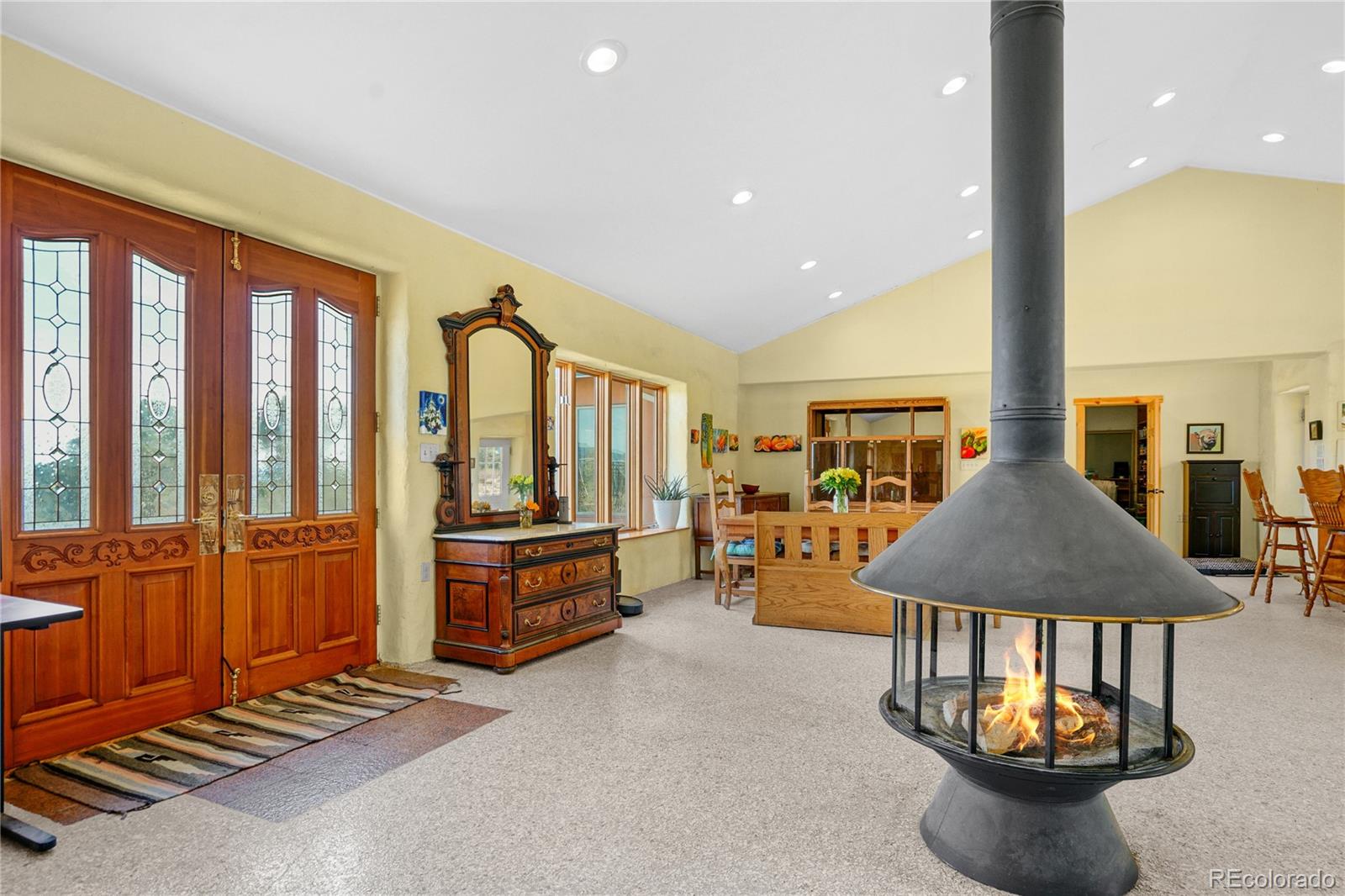 13045 Picketwire Road Boncarbo, CO 81024 - Photo 8 of 40 a living room with furniture a flat screen tv and a table