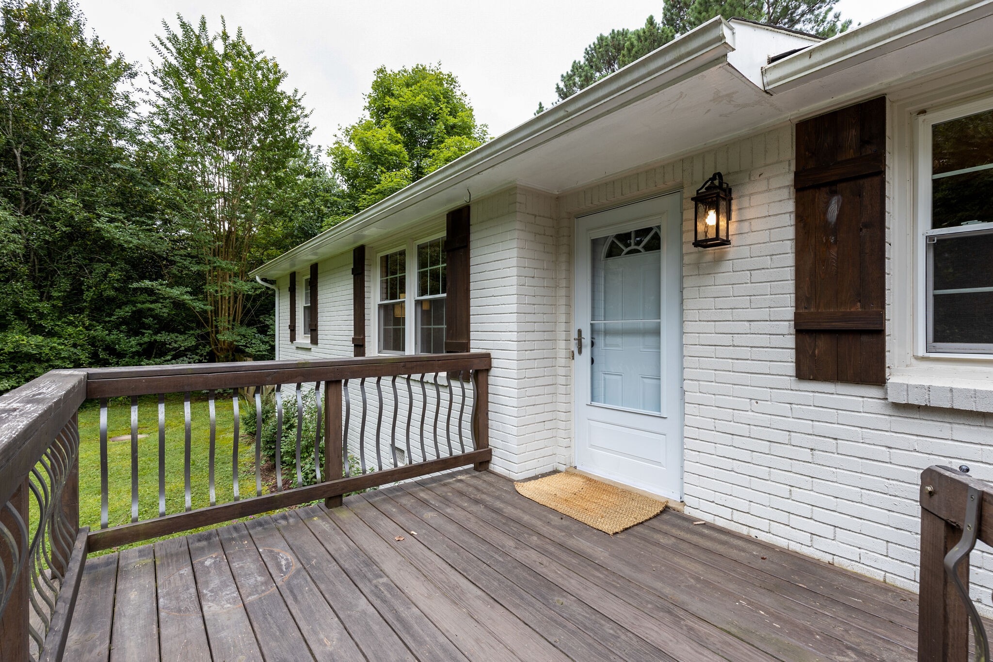 a view of a wooden deck and a yard