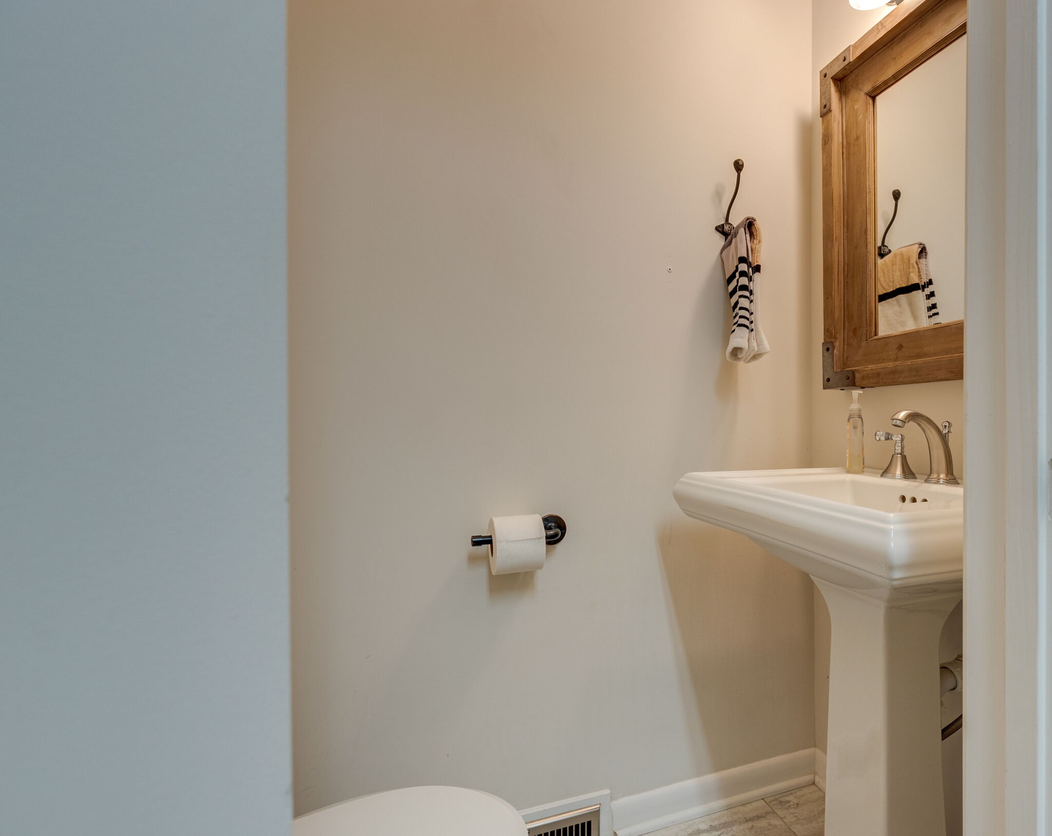 7316 Chester Road Fairview, TN 37062 - Photo 15 of 29 a bathroom with a sink and mirror with toilet