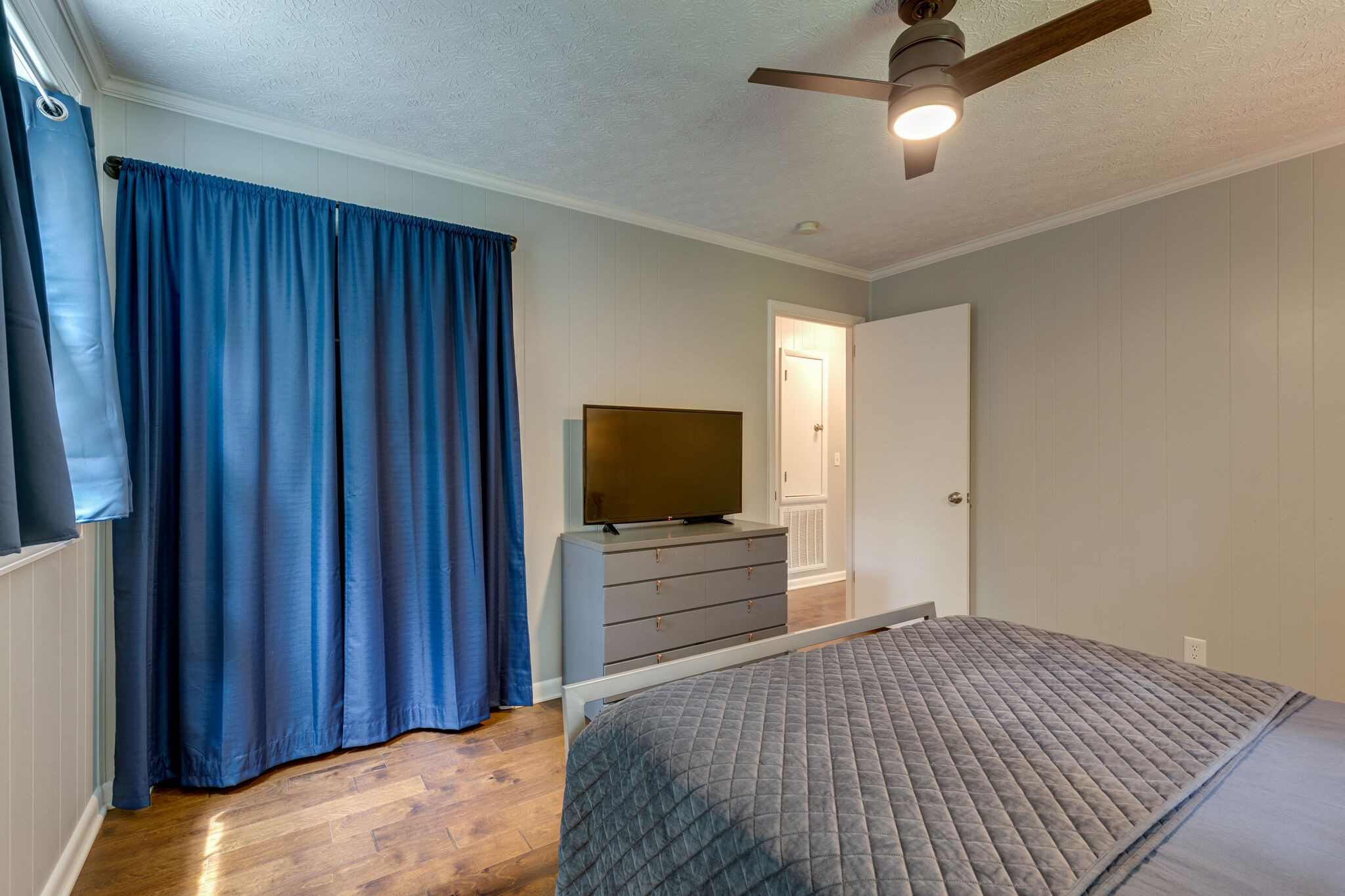 7316 Chester Road Fairview, TN 37062 - Photo 20 of 29 a bedroom with a bed and a flat tv screen on dresser