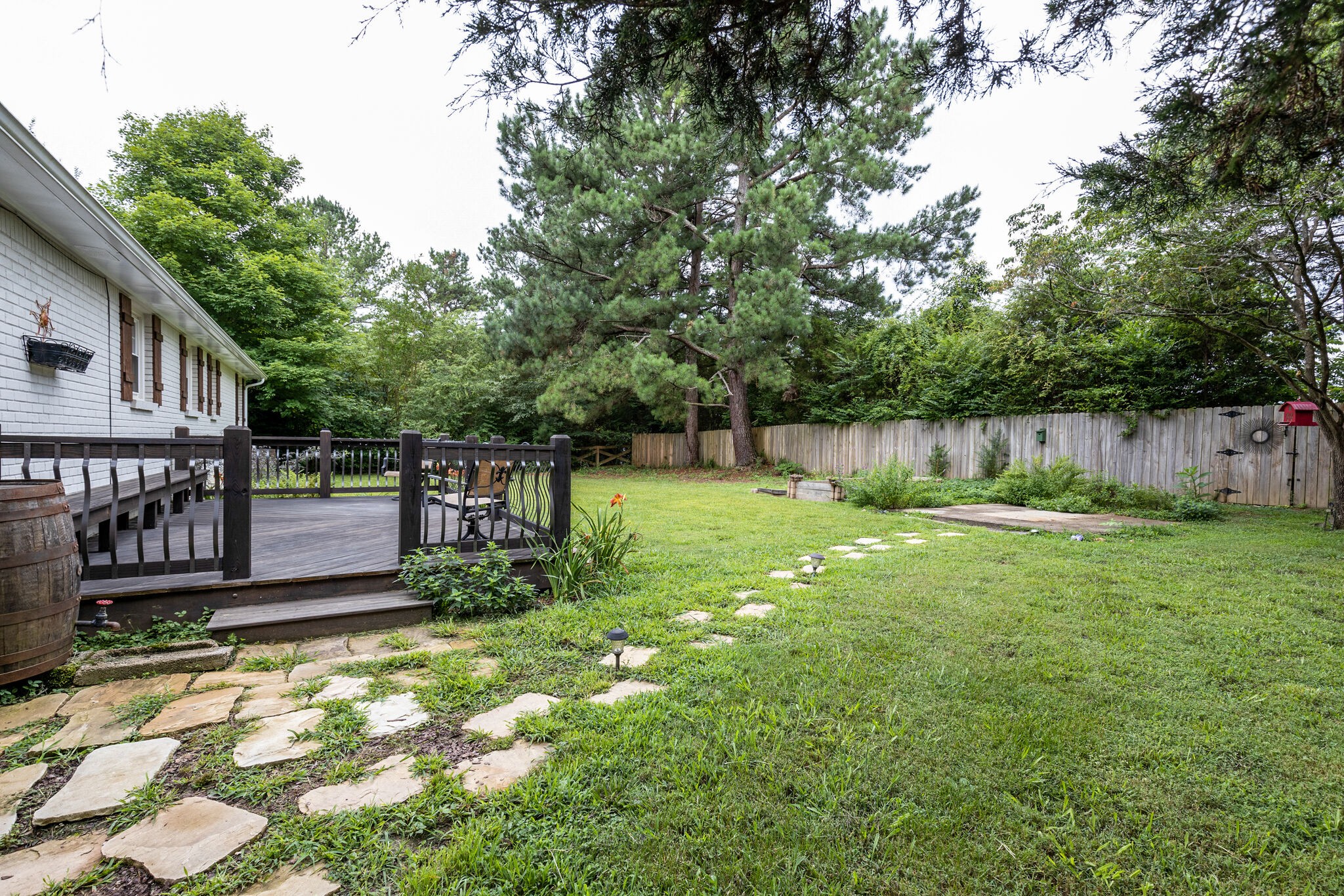 7316 Chester Road Fairview, TN 37062 - Photo 26 of 29 a view of a backyard with a small cabin and a chair