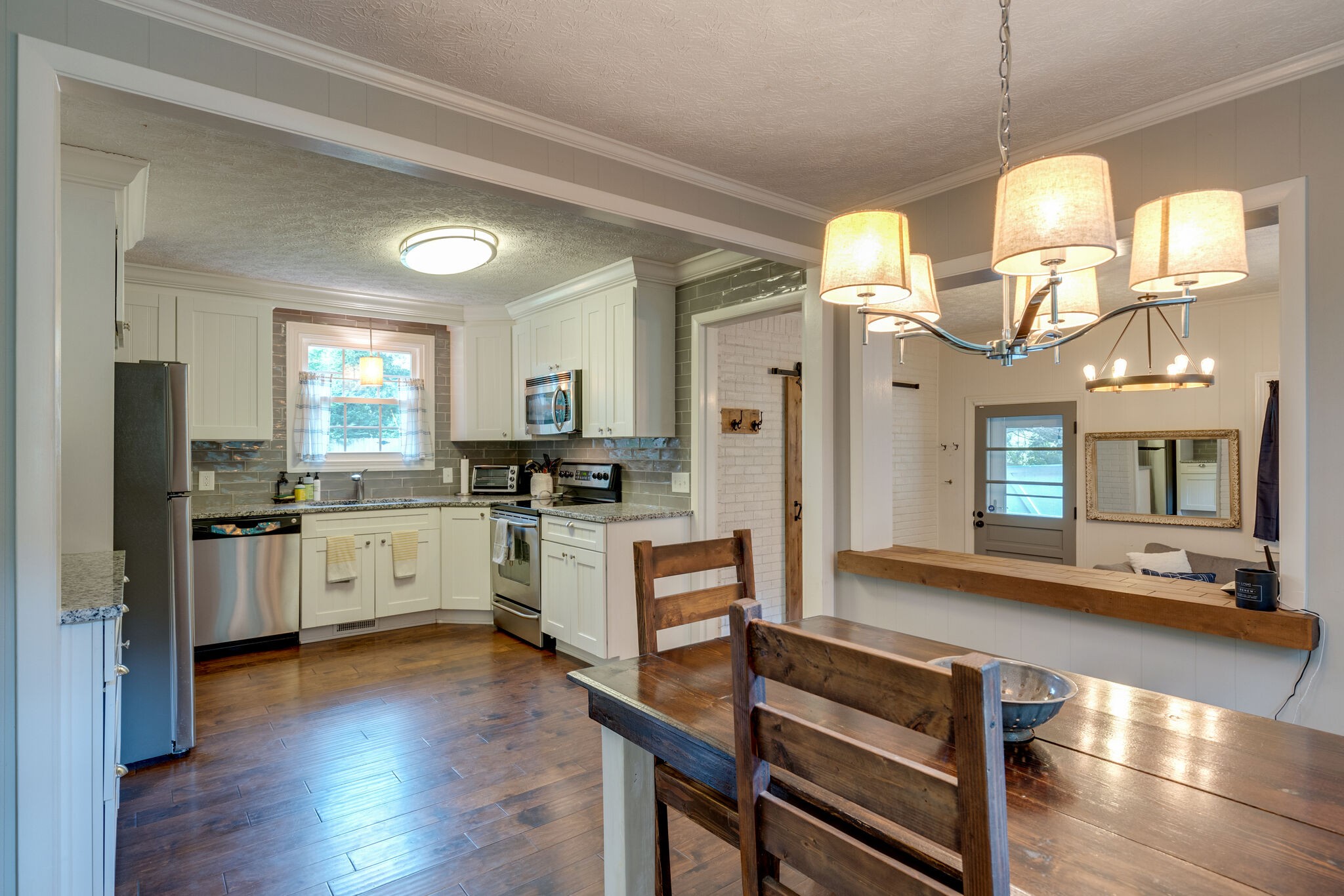 7316 Chester Road Fairview, TN 37062 - Photo 6 of 29 a large kitchen with cabinets a counter space dining table and a large window