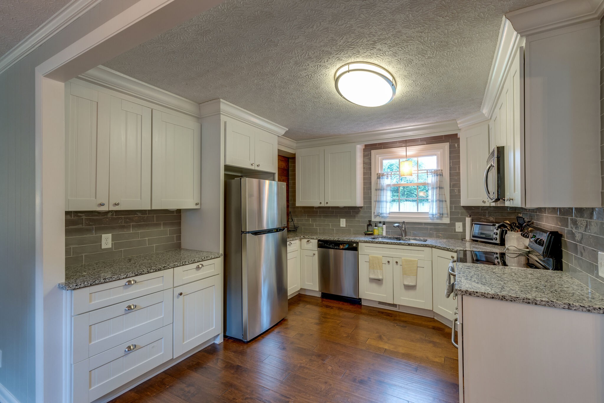 7316 Chester Road Fairview, TN 37062 - Photo 10 of 29 a kitchen with a refrigerator and a stove top oven