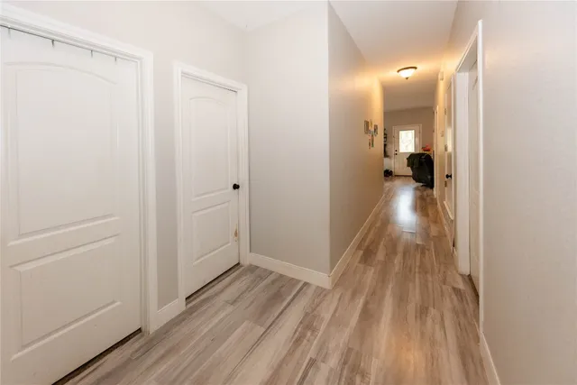 a view of a room with wooden floor