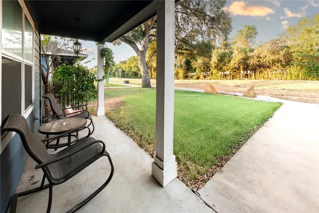 a view of a porch with furniture and garden