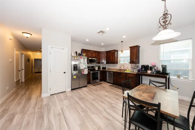 a kitchen with stainless steel appliances kitchen island granite countertop a sink counter space and cabinets