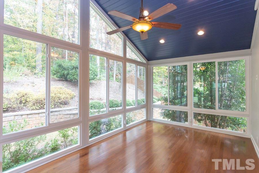 12816 Edsel Drive Raleigh, NC 27613 - Photo 12 of 25 a view of empty room with wooden floor and windows