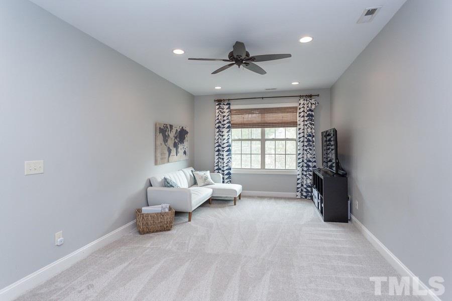 12816 Edsel Drive Raleigh, NC 27613 - Photo 13 of 25 a living room with furniture and a chandelier
