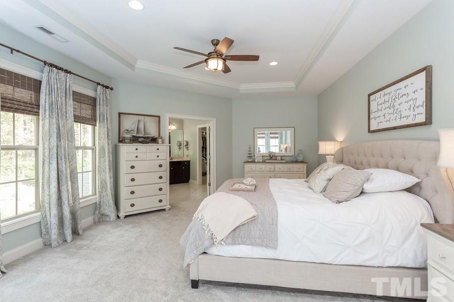 12816 Edsel Drive Raleigh, NC 27613 - Photo 15 of 25 a bedroom with a bed and wooden floor