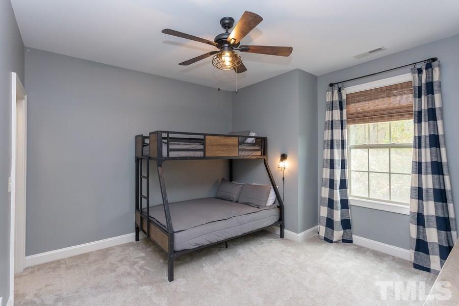 12816 Edsel Drive Raleigh, NC 27613 - Photo 18 of 25 a bed room with a bed and a window