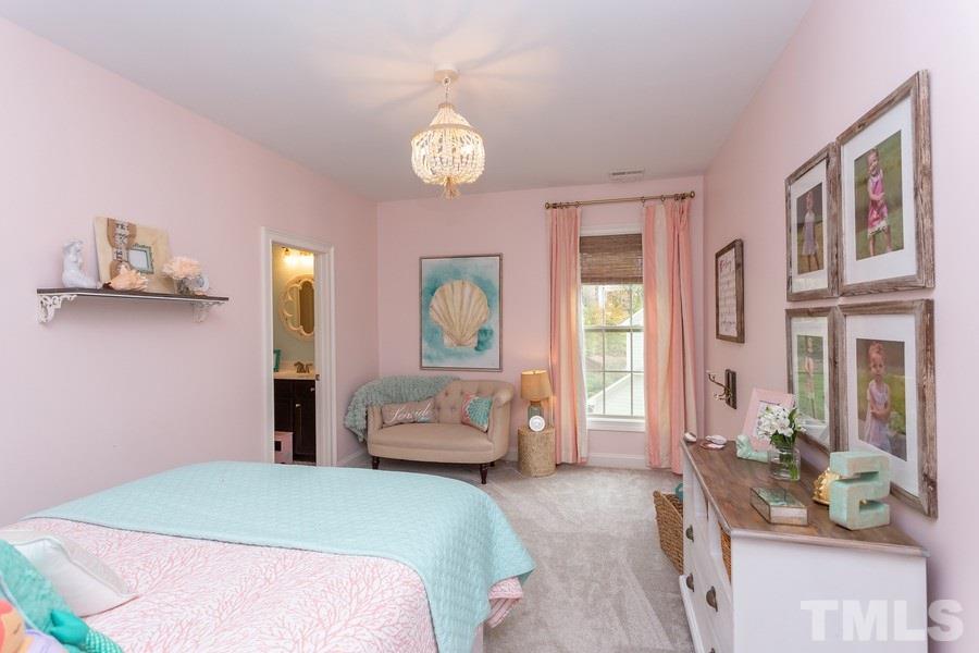 12816 Edsel Drive Raleigh, NC 27613 - Photo 21 of 25 a bedroom with a large bed and a couch