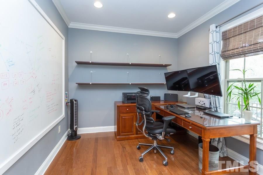 12816 Edsel Drive Raleigh, NC 27613 - Photo 4 of 25 a workspace with furniture and wooden floor