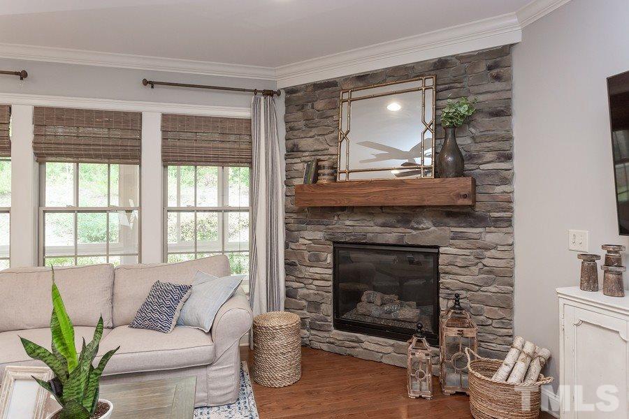 12816 Edsel Drive Raleigh, NC 27613 - Photo 6 of 25 a living room with furniture and a fireplace