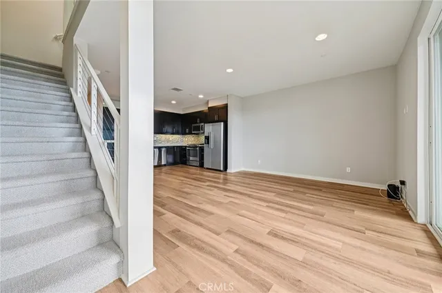 a kitchen with stainless steel appliances granite countertop a refrigerator and a sink