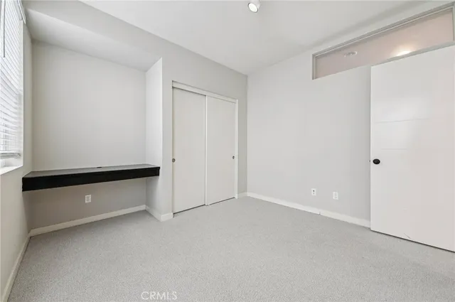 an empty room with chandelier fan