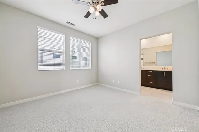 a bath room with a sink vanity tub and a mirror